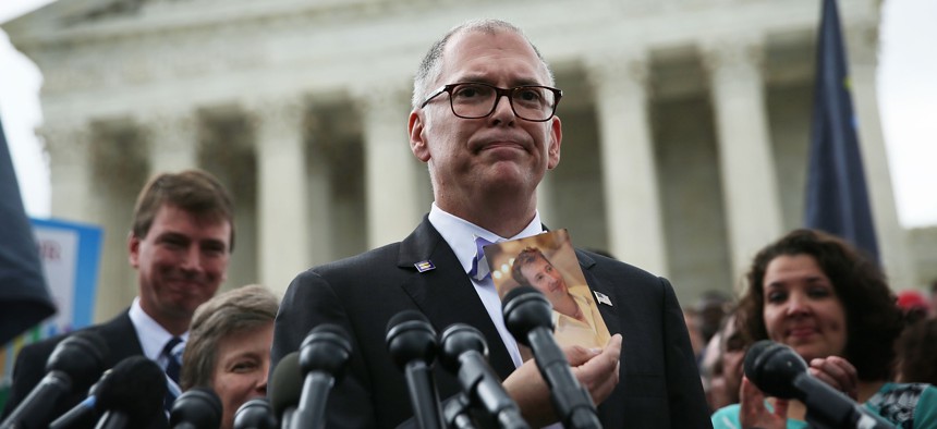  Jim Obergefell holds a photo of his late husband John Arthur as he speaks to members of the media after the U.S. Supreme Court handed down a ruling regarding same-sex marriage June 26, 2015 outside the Supreme Court in Washington, DC. 