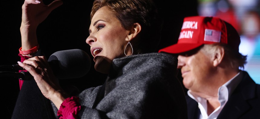 Republican governor candidate for Arizona Kari Lake speaks as former President Trump looks on at a rally Jan. 15 in Florence, Arizona.