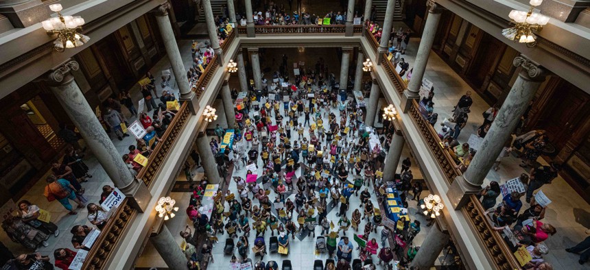 Anti-abortion and abortion rights activists protest on multiple floors within the Indiana State Capitol rotunda on July 25, 2022 in Indianapolis, Indiana.