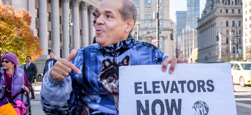 A participant on a wheelchair protesting outside a courthouse in New York City in 2019, while a judge held a hearing inside in a lawsuit brought to require elevators in all of the city's subway stations.