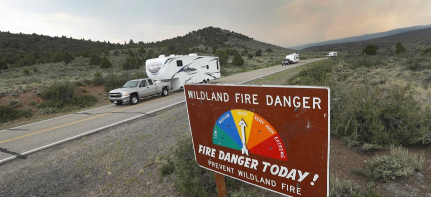 People remove travel trailers down highway 143 from their homes that have been evacuated due to a wildfire in Utah in 2017.