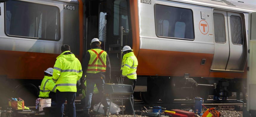 T officials inspecting the derailment of the Orange Line T train just outside the Wellington MBTA station in Medford, Massachusetts, on March 16, 2021.