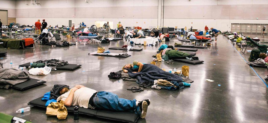 People rest at the Oregon Convention Center cooling station in Oregon, Portland on June 28, 2021, as a heatwave moves over much of the United States. 