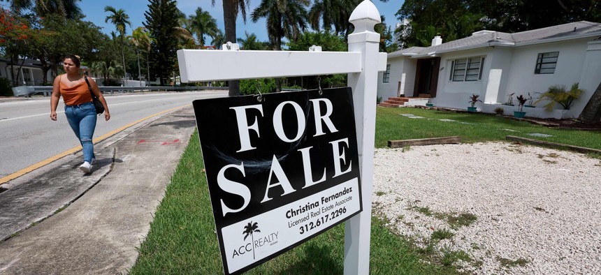 A 'for sale' sign hangs in front of a home on June 21, 2022 in Miami, Florida.