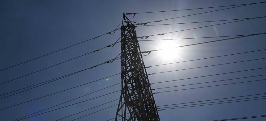 The sun shines behind electrical power lines during a heat wave in Hawthorne, California, on Sept. 6, 2022.