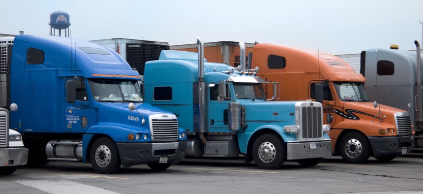 Trucks parked at an interstate truck stop.