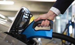 A person charges an electric vehicle at an EVgo charging station at Union Station in Washington on Thursday, April 22, 2021. 