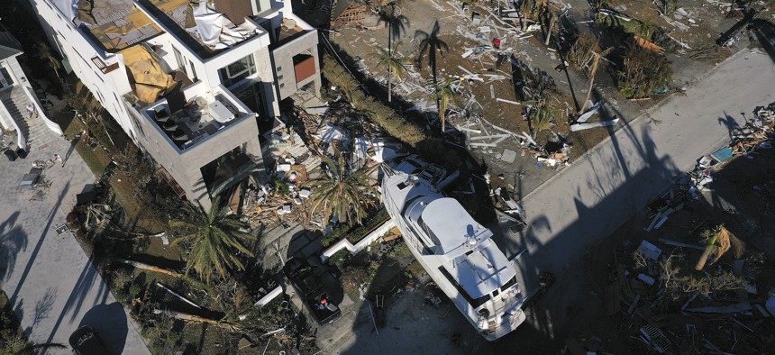 In this aerial view, a yacht sits in the front yard of a home in the wake of Hurricane Ian on October 02, 2022 in Fort Myers, Florida.