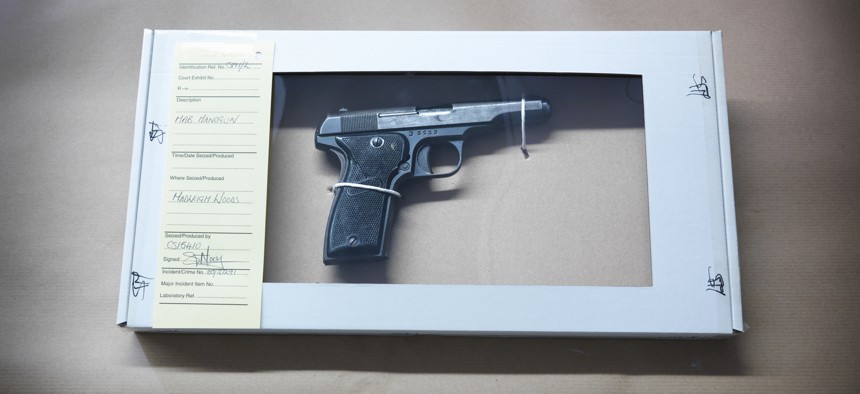 A forensic science evidence box containing gun from crime scene.