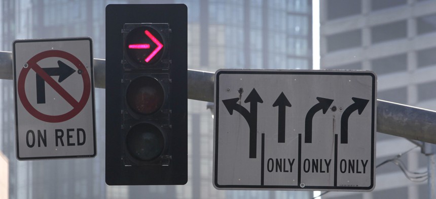 A sign indicates that right turns on red are prohibited at a San Francisco intersection.