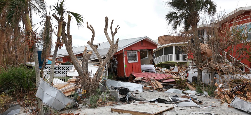 A destroyed building sits among debris after Hurricane Ian passed through the area.