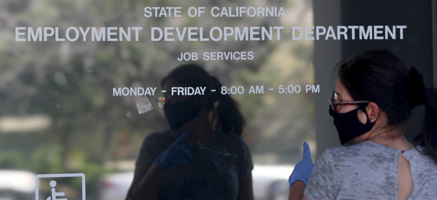 A resident seeks information about her unemployment claim but finds the California State Employment Development Department closed due to coronavirus, on Thursday, May 14, 2020 in Canoga Park, California. The state borrowed billions from the federal government to pay unemployment benefits during the pandemic.