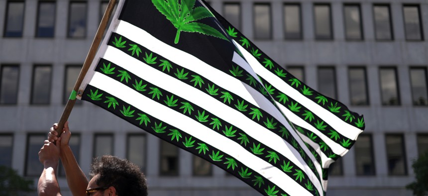 A marijuana activist holds a flag during a march on Independence Day on July 4, 2021 in Washington, DC. 