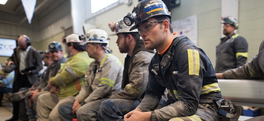 In this 2017 photo, coal miners wait for the arrival of former Environmental Protection Agency Administrator Scott Pruitt who visited the Harvey Mine, in Sycamore, Pennsylvania.