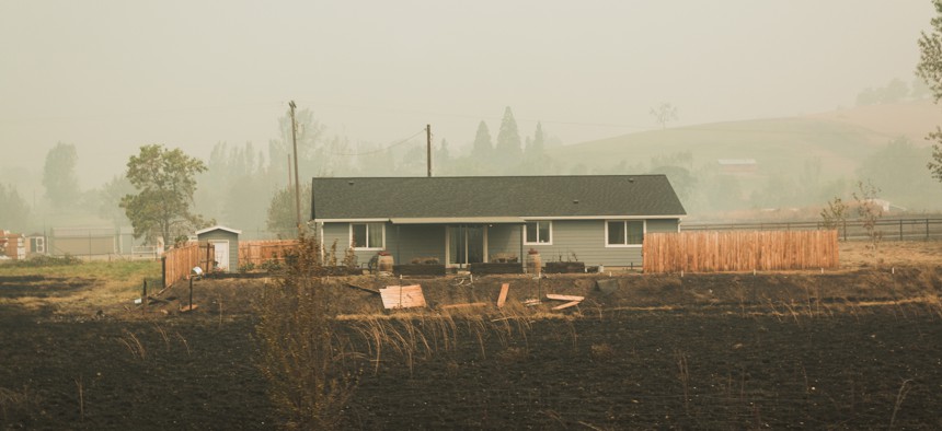 A single family home in Oregon after wildfire destroyed surrounding land. 