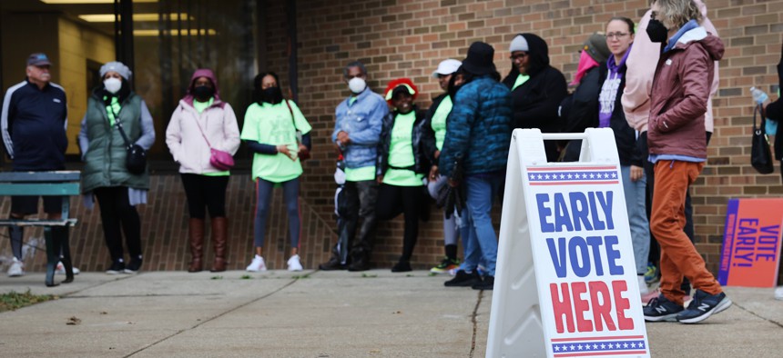  People wait in line outside a polling place at the start of early voting on October 25, 2022 in Milwaukee, Wisconsin. 