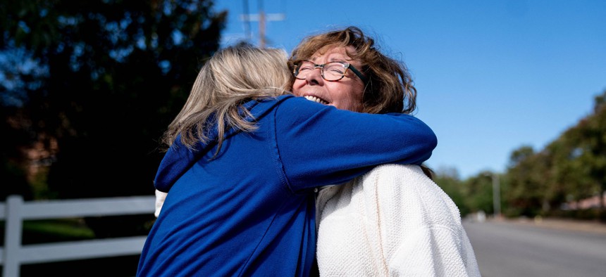 Molly Kimbrell hugs Kim Blankenship while volunteering with Protect Kentucky Access in Lexington, Kentucky, on October 1, 2022. 