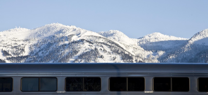 An Amtrak train passes in front of the Whitefish Mountain Ski Resort in northern Montana.