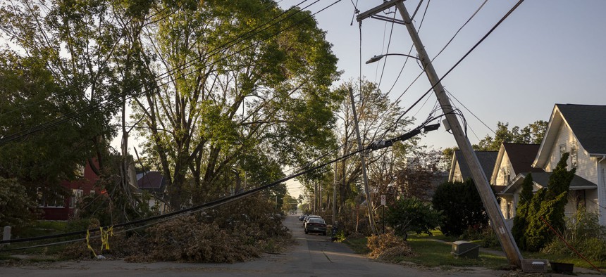 CEDAR RAPIDS, IA - AUGUST 16: A downed power line leans over a street in Cedar Rapids, Iowa on Sunday, August 16, 2020. A rare Derecho storm battered large sections of Cedar Rapids leaving people homeless and without power. 
