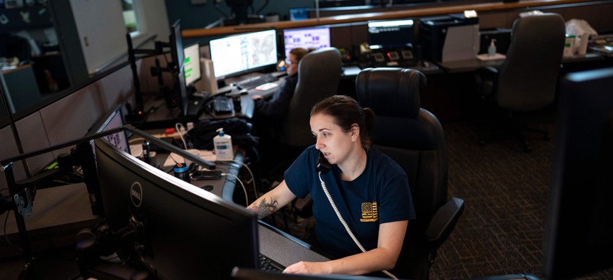 A dispatcher with Anne Arundel County Fire Department answers a 911 emergency call. Between 18% and 24% of these professionals exhibit PTSD symptoms.