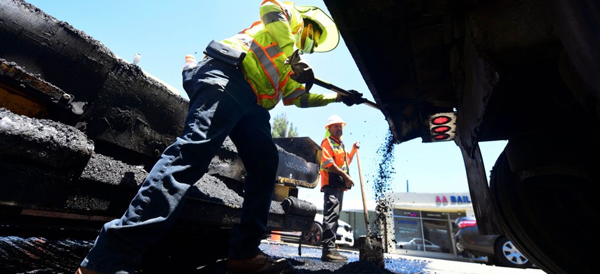 A roadworks crew work on road resurfacing on June 24, 2021 in Alhambra, California. 