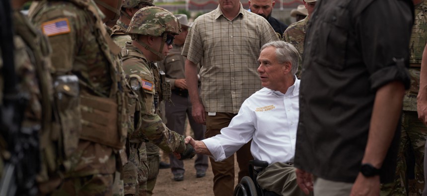 Texas Gov. Greg Abbott tours the US-Mexico border at the Rio Grande River in Eagle Pass, Texas, in May.