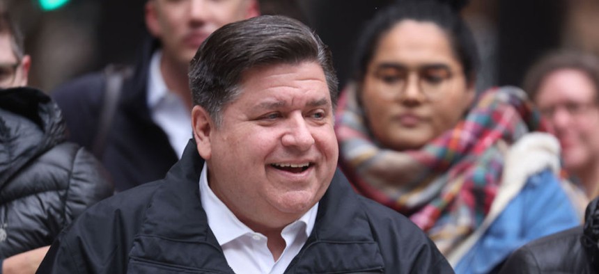 Illinois Gov. J.B. Pritzker recently shared plans to spend the state’s budget surplus on expanding pre-K and pay raises for child care workers. In this file photo, he listens to speakers during a transgender support rally on April 27, 2022 in Chicago.