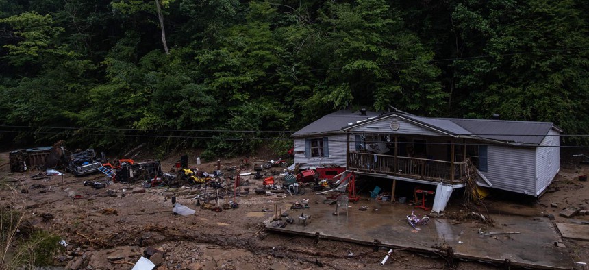 Debris surrounds a badly damaged home near Jackson, Kentucky, on July 31, 2022, after historic flooding swept through eastern Kentucky.