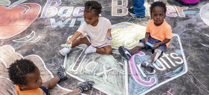 Children from the KU Kids Deanwood Childcare Center complete a mural celebrating the launch of the Child Tax Credit on July 14, 2021 at the KU Kids Deanwood Childcare Center in Washington, DC.
