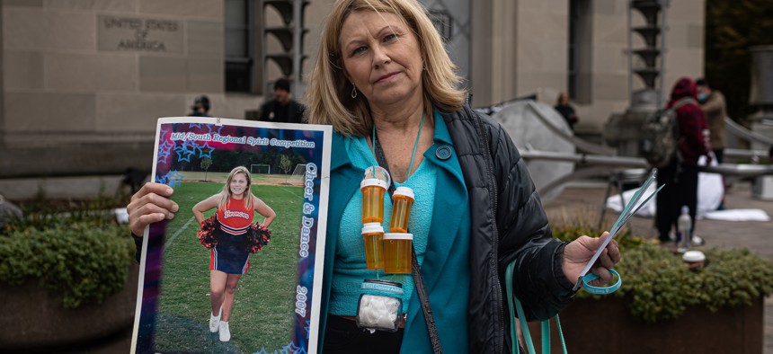Susan Stevens carries her daughter Toria's ashes around her neck since she died of an opioid overdose in 2018. Billions in opioid settlement funds are heading to state and local governments, but it’s not clear what role the federal government will play in overseeing how those sums are spent. 