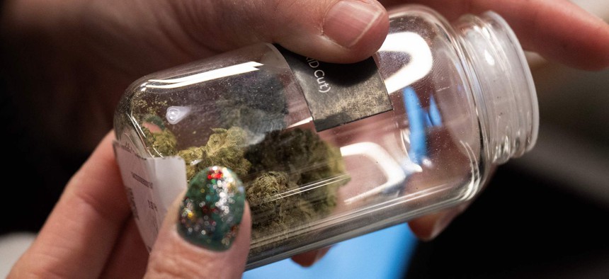 A customer looks at marijuana buds at the Proper Cannabis dispensary in Kansas City, Missouri, on March 17, 2023.