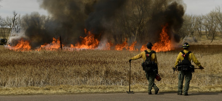Firefighters keep an eye on a prescribed burn at the Rocky Mountain Arsenal National Wildlife Refuge on April 5, 2021 in Denver, Colorado.
