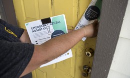 Jennifer Hernandez passes out fliers at an apartment complex in the Greenspoint area alerting residents about the Houston-Harris County Emergency Rental Assistance Program in 2021.