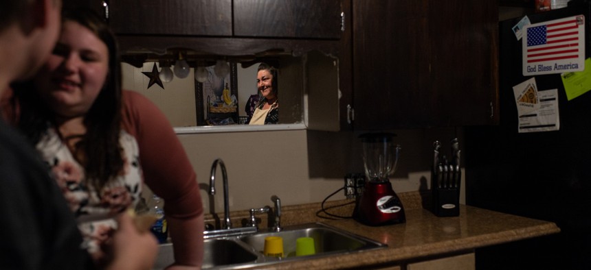 Rebecca Hale looks over at her teenage daughter, Chloe, and Chloe's boyfriend, at home in Tulsa, Oklahoma. Hale is a graduate of the Women in Recovery program.