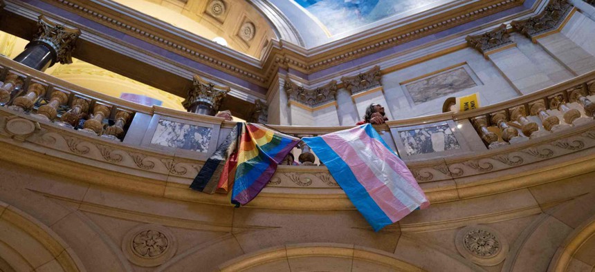 LGBTQ+ activists rally before the Minnesota Senate introduced the Trans Refuge Bill at the State Capitol Building in Saint Paul, Minnesota, in April. The Minnesota legislature passed a "trans refuge" bill that guarantees legal protection for trans people coming to Minnesota from elsewhere to access medical care. 