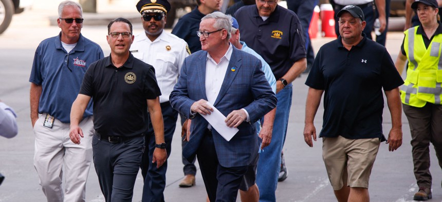 Pennsylvania Governor Josh Shapiro (left) and Philadelphia Mayor James F. Kenney walk near a collapsed portion of Interstate 95, caused by a large vehicle fire, in Philadelphia on June 11.