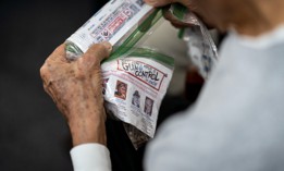 A man holds a ziplock bag filled with antisemitic messaging in Ormond Beach, Fla. 
