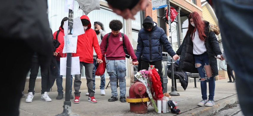Friends and classmates from Rauner College Prep visit a memorial for 15-year-old Caleb Westbrooks, a victim of gun violence, in the West Town neighborhood in Chicago, Illinois, on Jan. 19, 2022.