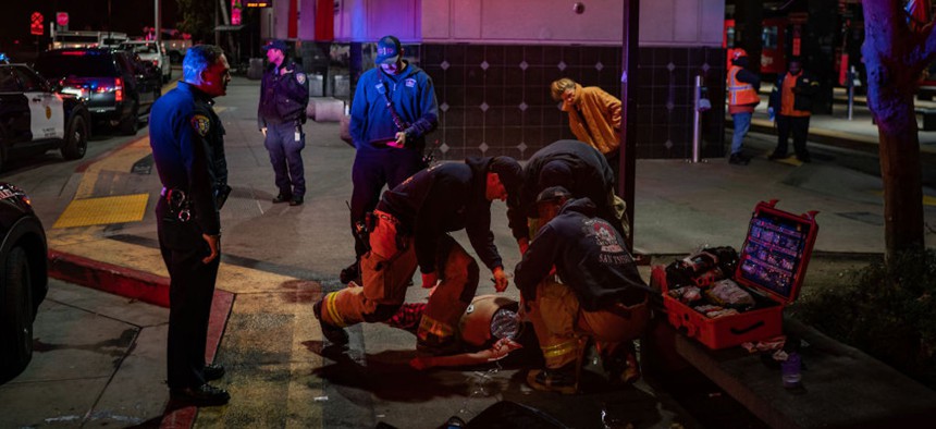 San Diego Police officers and paramedics try to revive a woman who overdosed on fentanyl in San Diego, California on Friday, November 11, 2022.