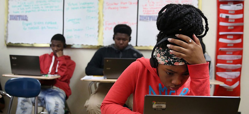 Students at TechBoston Academy, including eighth-grader Kajiah Scott, 13, use technology from EdVestors to learn math on Oct. 15, 2015. 