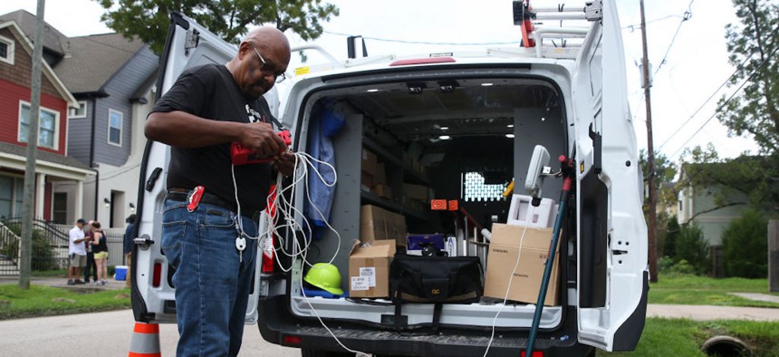 Verizon contractor Darryl McQueen, of Asurion, gets ready to test the 5G broadband signals at Clayton and Emily Harris' house in the Heights on Monday, Oct. 1, 2018, in Houston. The Harrises were the first Verizon 5G broadband customers in the nation.