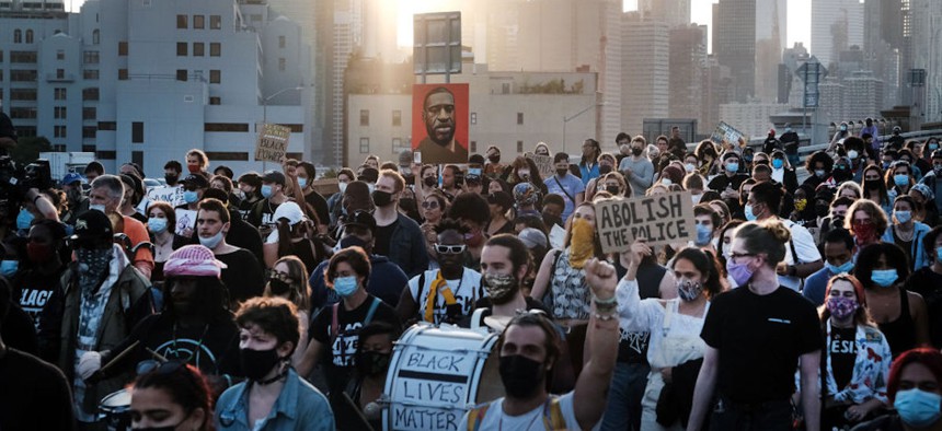 A crowd marches across the Brooklyn Bridge on May 25, 2021, in New York City to honor George Floyd on the one year anniversary of his death. Floyd death in Minneapolis police custody sparked nationwide protests with advocates calling for more police accountability.