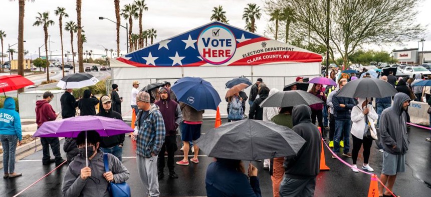 On a rainy Election Day, Nevadans stand in long lines to cast their votes at Centennial Center polling place in Las Vegas, Nevada, on Nov. 8, 2022.