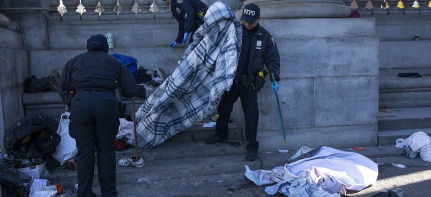 New York City police officers clear an encampment after Mayor Eric Adams ordered the city to enforce homeless sweeps.