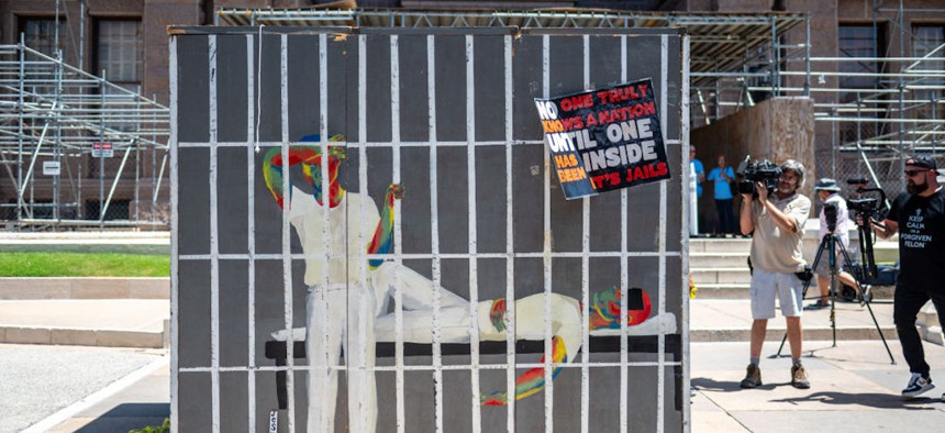 A mock prison cell, intended to simulate the heat inside prision cells in Texas, sits outside the Texas State Capitol building in Austin, Texas, on July 18, 2023. Activists visited the capitol to discuss the need for air conditioning in state prisons, citing the harsh conditions and multiple deaths related to the heat and lack of relief from it. 