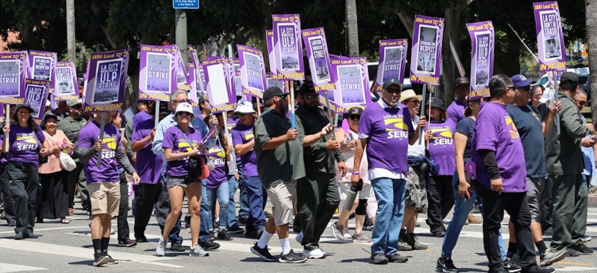 Los Angeles city workers holding placards gather at City Hall during a 24-hour strike over unfair labor practice on Aug. 8, 2023 in Los Angeles, California. 