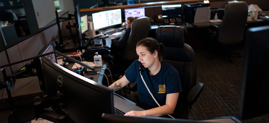 A dispatcher with Anne Arundel County Fire Department answers a 911 emergency call from their department dispatch center in Glen Burnie, Maryland. 