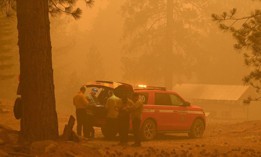 Firefighters plan strategy in the evacuation zone of the Dixie Fire, in Twain, California on July 26, 2021.