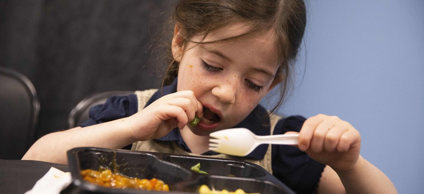 Kindergartner Ada Urum tastes the new school lunches in her Boston school in 2022.