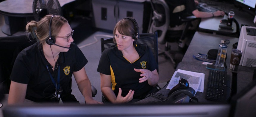 Dispatcher Kendra Dodd, right, asks questions to dispatcher Torrie Dehn during her training session at Colorado State Patrol Dispatch Center in Lakewood, Colorado, on Aug. 2, 2023.